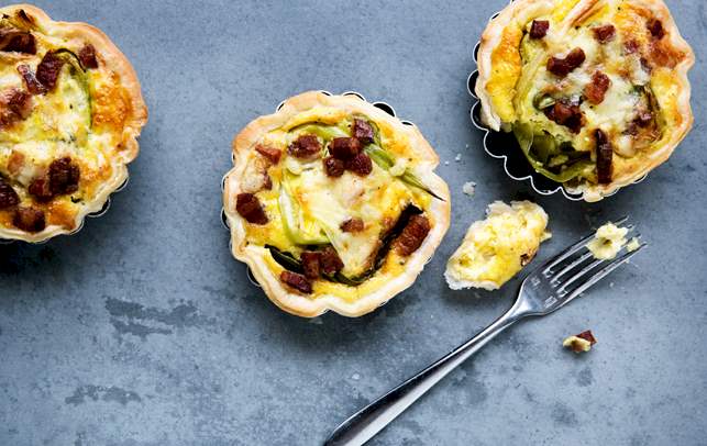 Små tærter med cheddar, bacon og bagte forårsløg. Små tærter med cheddar, bacon og bagte forårsløg