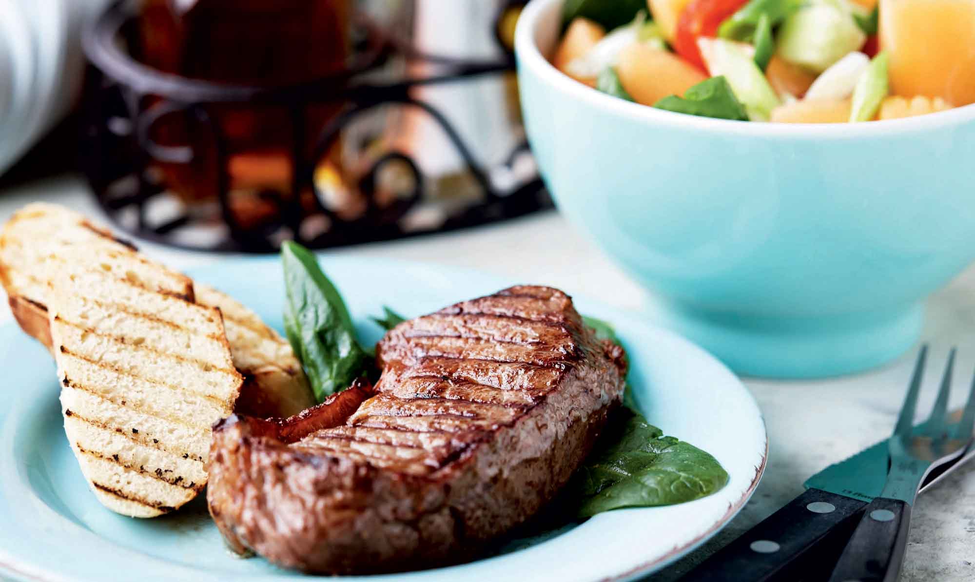 Saftige bøffer på grillen med en frisk salat til - det er lækker sommermad. Grillbøffer med melonsalat